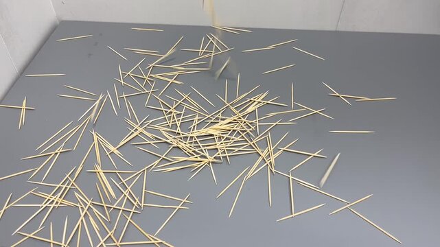 Wooden toothpicks dropping, knocking onto the MDF