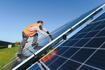Worker installing solar panels for renewable energy