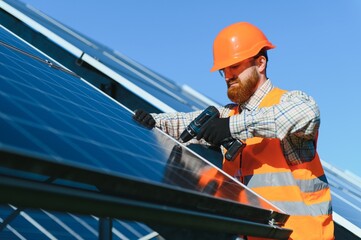 Fototapeta premium Skilled technician installing solar panels for green energy