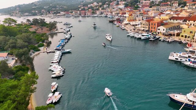 Aerial Drone View of the Colorful Waterfront Promenade of Gaios Town in Paxos Greece with Busy Marine Traffic and Traditional Venetian Architecture in Summer