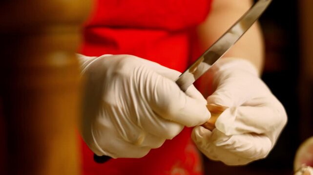 Person wearing gloves is peeling the garlic cloves