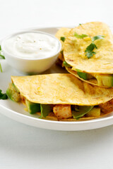 Chicken avocado quesadillas served with sauce