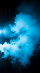 Fototapeta premium Vibrant blue smoke on dark background.