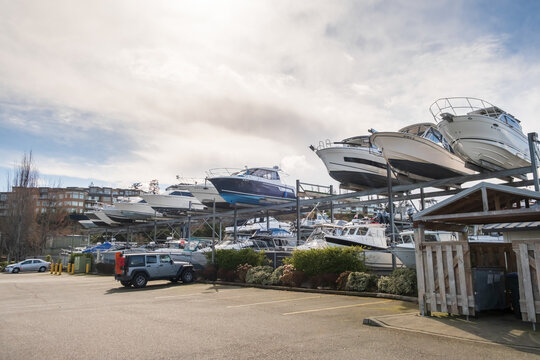 Edmonds, Marina Beach Park, WA, 03.13.2025 - boats with engines in a multi-level parking lot