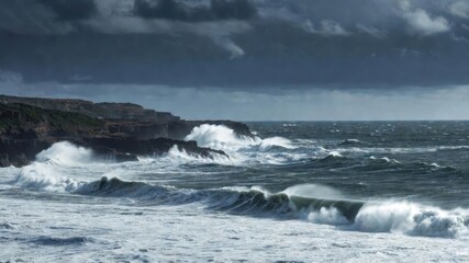 Dramatic ocean waves crashing against rocky coastline under stormy sky.