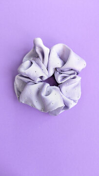 Scrunchie for hair isolated on violet background