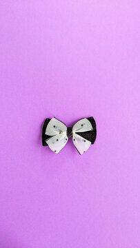 Aesthetic fancy elegant bow design element on colourful background.