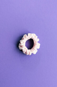 Scrunchie for hair isolated on violet background