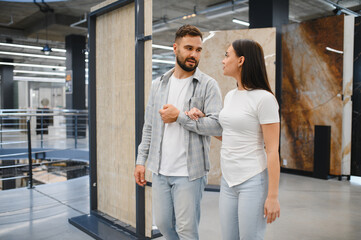 Fototapeta premium Couple choosing floor tiles for home renovation