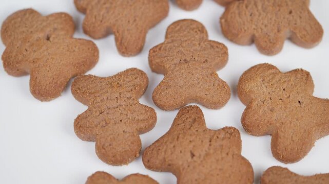 Sweet treats with warm details. Closeup of spicy gingerbread cookies on clean tabletop. Studio shot featuring crisp gingerbread bites with subtle spice and inviting warmth