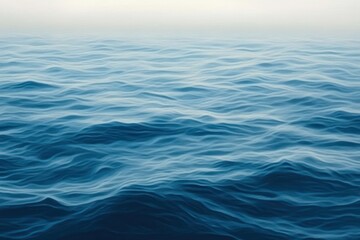 Obraz premium endless blue ocean waves under a soft hazy horizon, calm and peaceful mood