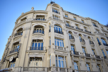 Obraz premium Elegant Historic Building Facade with Balconies and Ornaments in Madrid, Spain