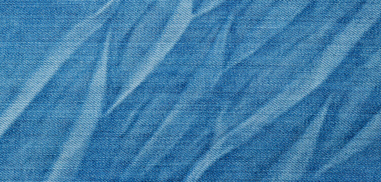 Blue denim fabric texture with crumpled folds background