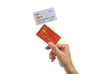 Hand holding a red credit card with a white credit card flying above it, isolated on white background.