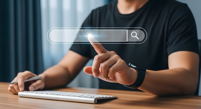 A man points his finger at a glowing, transparent virtual search bar overlayed above a modern computer keyboard.