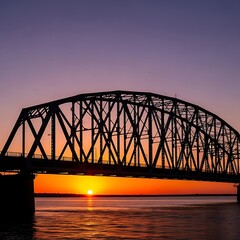 Obraz premium Sunset over steel bridge water.