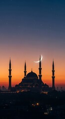 Fototapeta premium Mosque silhouette at sunset with crescent moon.