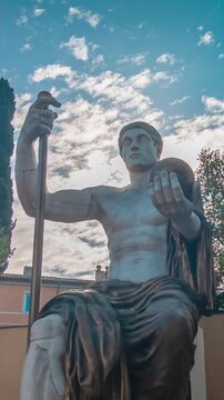 Giant reconstruction of the ancient Roman emperor Constantine statue holding a sphere and a scepter, a majestic historical marble monument located in the Capitoline Museums in Rome, Italy