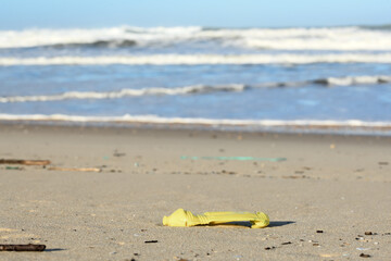 Plastic and wood waste after a storm polluting the beach