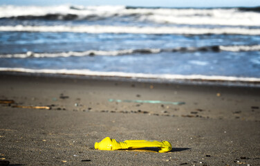 Plastic and wood waste after a storm polluting the beach