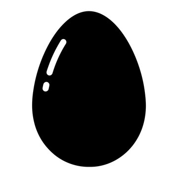 A black egg with a white spot on a white background