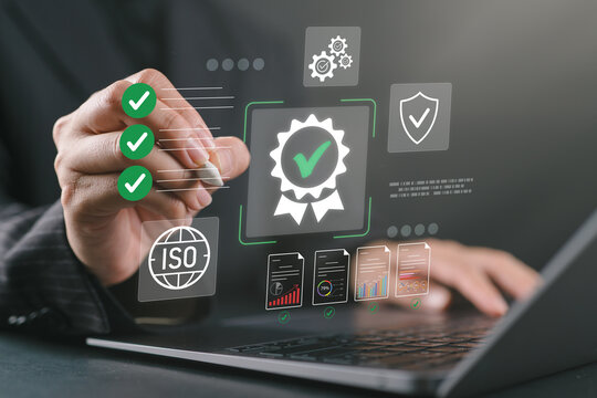 Business professional using laptop for ISO certification and compliance, with digital checklist, quality assurance, document validation, and performance monitoring.