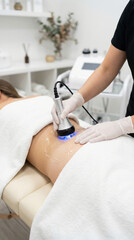 Fototapeta premium Beautician performing ultrasonic cavitation procedure for buttocks contouring and cellulite reduction on a woman in a modern spa clinic