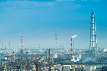 Fototapeta premium equipment of gas oil refining plant in Japan industrial factory area with blue sky background view from Fishing port, Yokkaichi, Mie Prefecture, Japan.