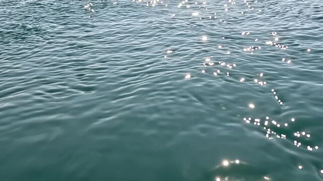 Water, ocean, sea shimmering surface sparkling sunlight, peaceful natural blue background texture