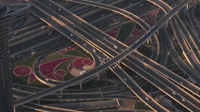 Dubai Metro passing over busy intersection in Dubai seen from above, UAE