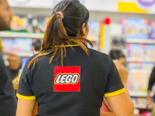 Fototapeta premium Lego store staff member wearing the themed shirt looking at the rush of customers in Delhi's first LEGO store during the opening days