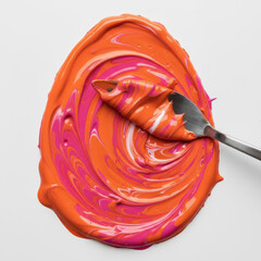 Mixed orange and pink paint with a palette knife on a white background, symbolizing art, creativity, or color blending