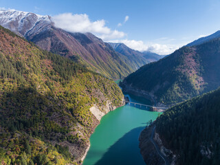 Aerial View of Duonuo Hydropower Station with Emerald Reservoir and Lush Mountains, Baishuijiang River, Sichuan, China