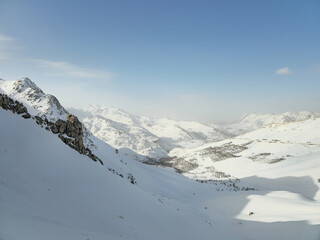 Expansive snowy mountain landscape with rugged peaks, high-altitude valleys, and serene winter light under a clear sky, showcasing the untouched beauty of alpine nature.  
📍Hazarani, Hawraman Takht 