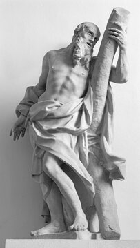 SALZBURG, AUSTIRA - SEPTEMBER 7, 2025: The stone statue of St. Andrew the Apostle in the church Andrea Kirche by Michael Bernhard Mandl (1660 - 1711).
