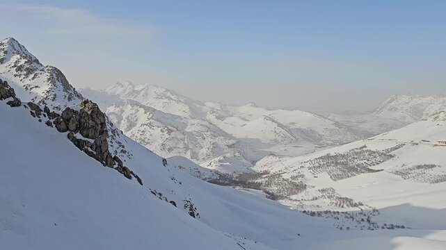 Expansive snowy mountain landscape with rugged peaks, high-altitude valleys, and serene winter light under a clear sky, showcasing the untouched beauty of alpine nature.  
📍Hazarani, Hawraman Takht 