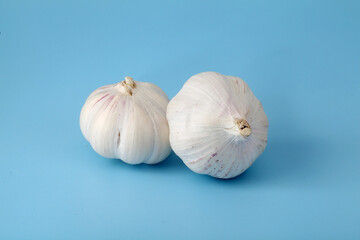whole garlic bulbs on blue background