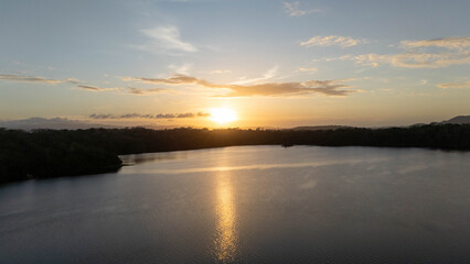 Obraz premium Aerial Sunrise Views of Madden Dam and Alajuela Lake in Chilibre Panama Drone Footage, Cinematic drone footage capturing the sunrise over Madden Dam and Alajuela Lake in Chilibre, Panama. The golden 
