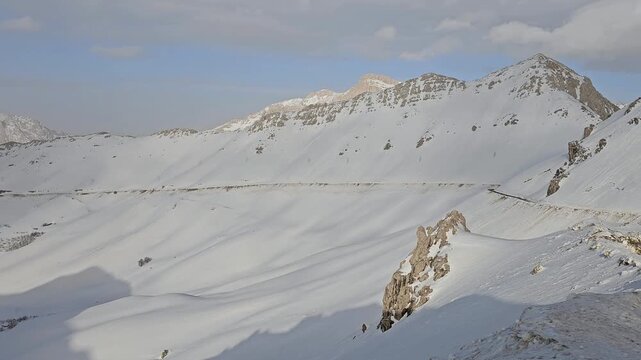 Expansive snowy mountain landscape with rugged peaks, high-altitude valleys, and serene winter light under a clear sky, showcasing the untouched beauty of alpine nature.  
📍Hazarani, Hawraman Takht 