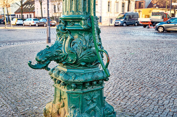 Historic water pump in the old town district of Rixdorf in Berlin.