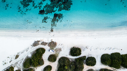 Camper van parked on Cala Banana beach, aerial top view, Sardinia, Italy. © Andrea Tabaro