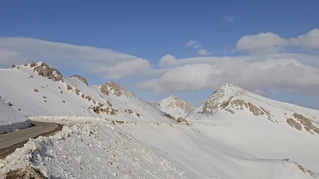 Snow-covered mountain landscape with a winding road under a clear blue sky, showcasing serene alpine scenery and the untouched beauty of a high-altitude winter environment.
📍Hawraman Takht, Kurdista