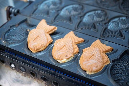 Taiyaki cooking on a traditional grill in Japan, close up of street food