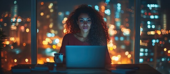 Obraz premium Woman works late at night, city view. Remote work