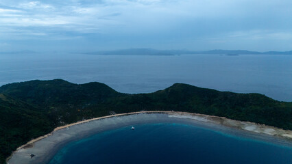Obraz premium Drone aerial view of Bayang Basecamp or Calibangbangan Camp and turquoise reef along Calibangbangan Island coastline between Coron and El Nido, Palawan, Philippines.