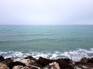 View of the sea from the cliff in the foggy day.
