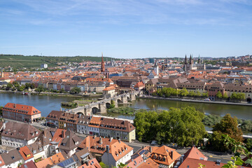 Obraz premium Panoramic view from Festung Marienberg overlooking Würzburg’s historic old town, the Main River and the iconic Old Main Bridge lined with monumental statues.