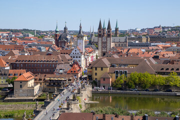 Obraz premium Panoramic view from Festung Marienberg overlooking Würzburg’s historic old town, the Main River and the iconic Old Main Bridge lined with monumental statues.