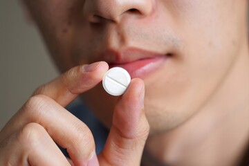 Close-up of Man Holding a Pill - Health and Medicine Concept