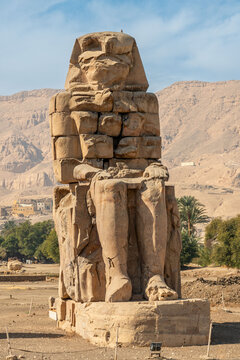 Massive Weathered Stone Statue of Pharaoh Amenhotep III at the Colossi of Memnon in the Theban Necropolis Luxor Egypt